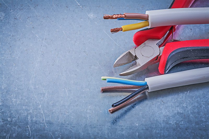 Zoomed in stripped electrical wires and wire cutters